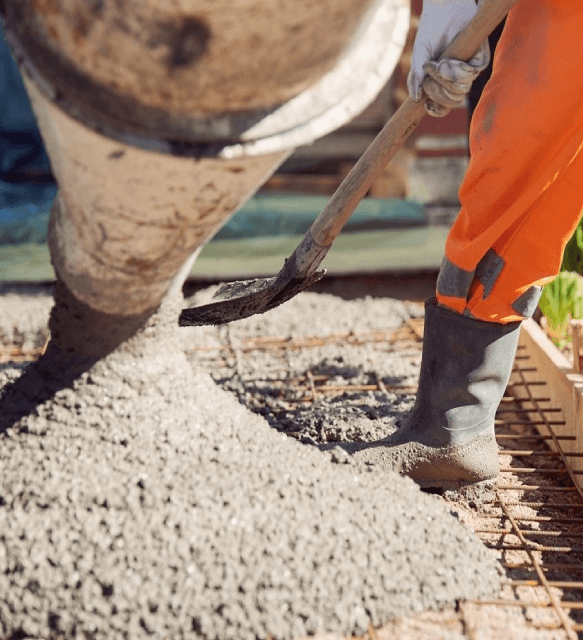 A person pouring cement into the ground.