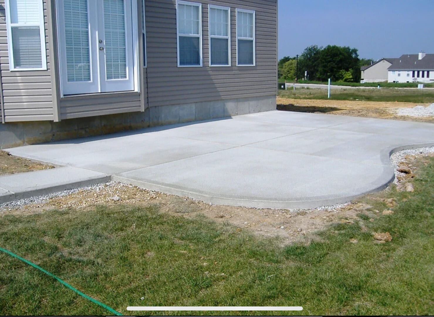 A concrete slab in the middle of a yard.